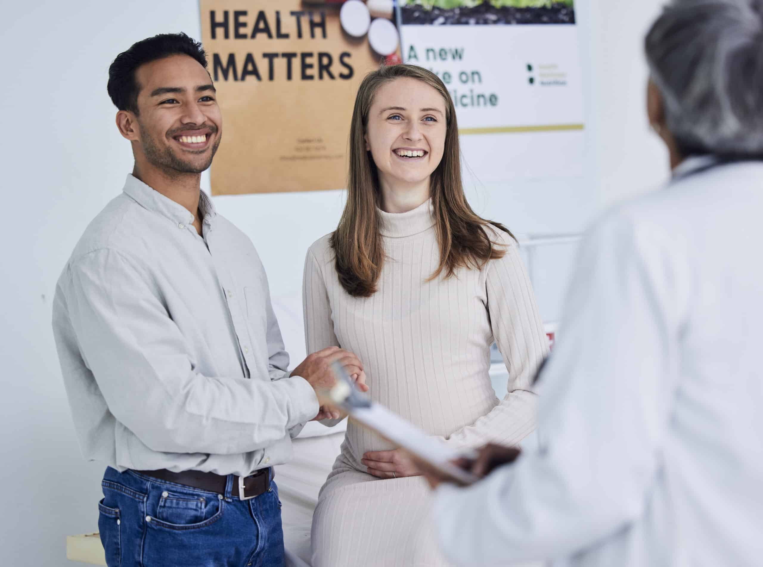 Family, planning and pregnant couple with doctor in consultation office for healthcare exam.